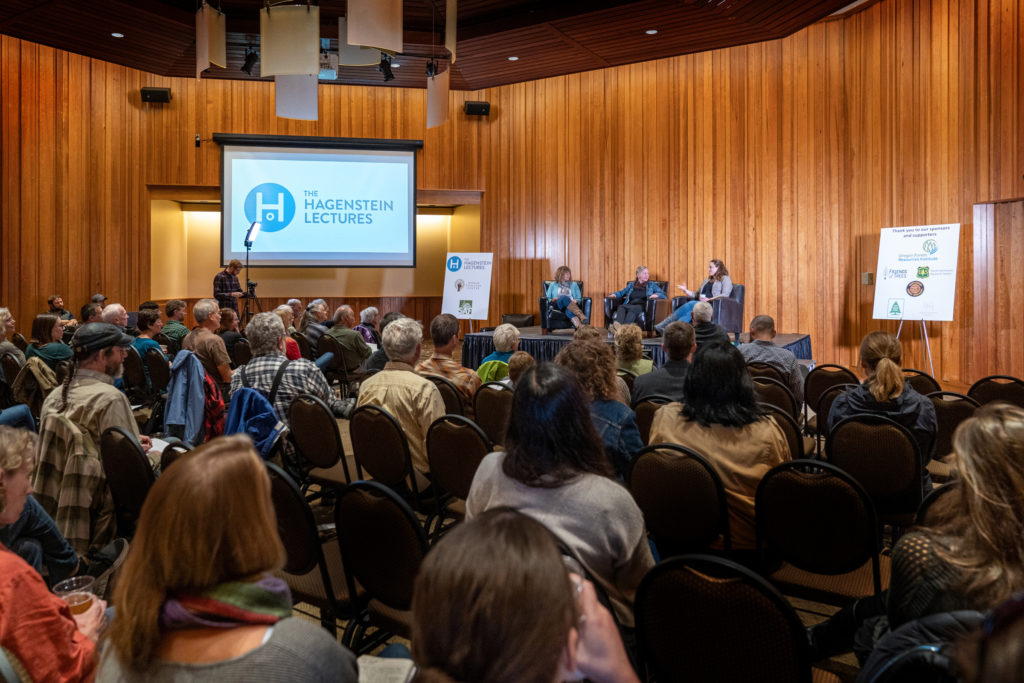The World Forestry Center regularly hosts events to connect the public to its interdependence on forests. Large group of people listen to a lecture speaker and watch a presentation