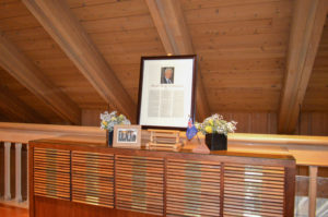 Leadership Hall induction display with flowers and framed photos