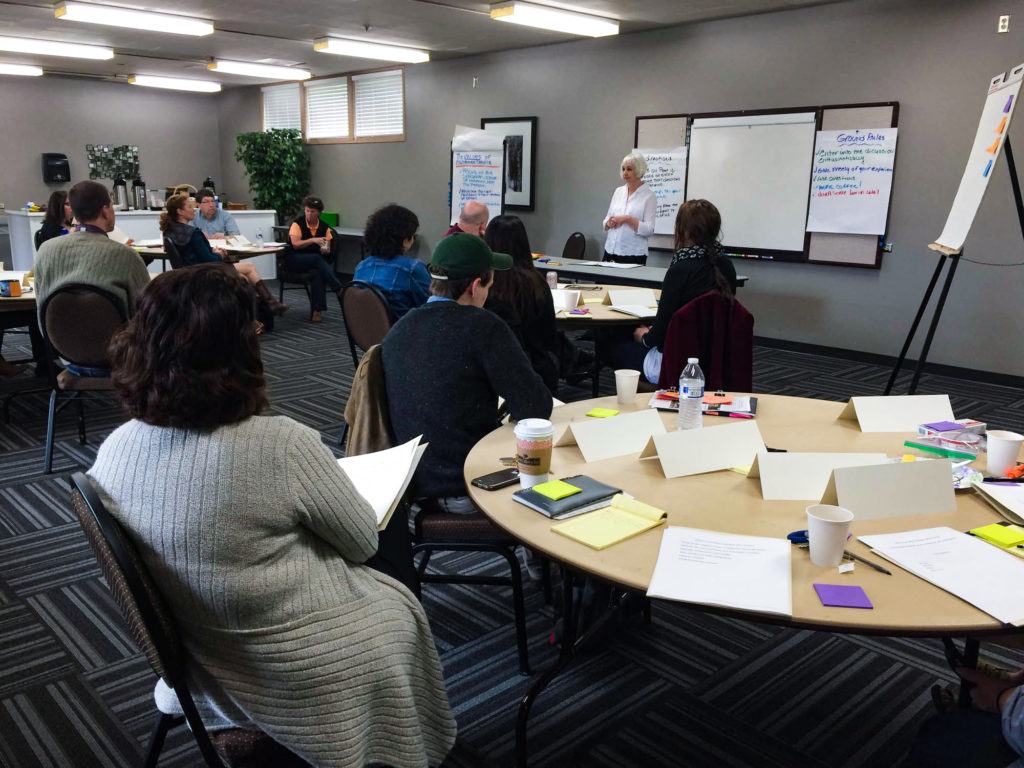 Group of people in a conference room watching a presentation