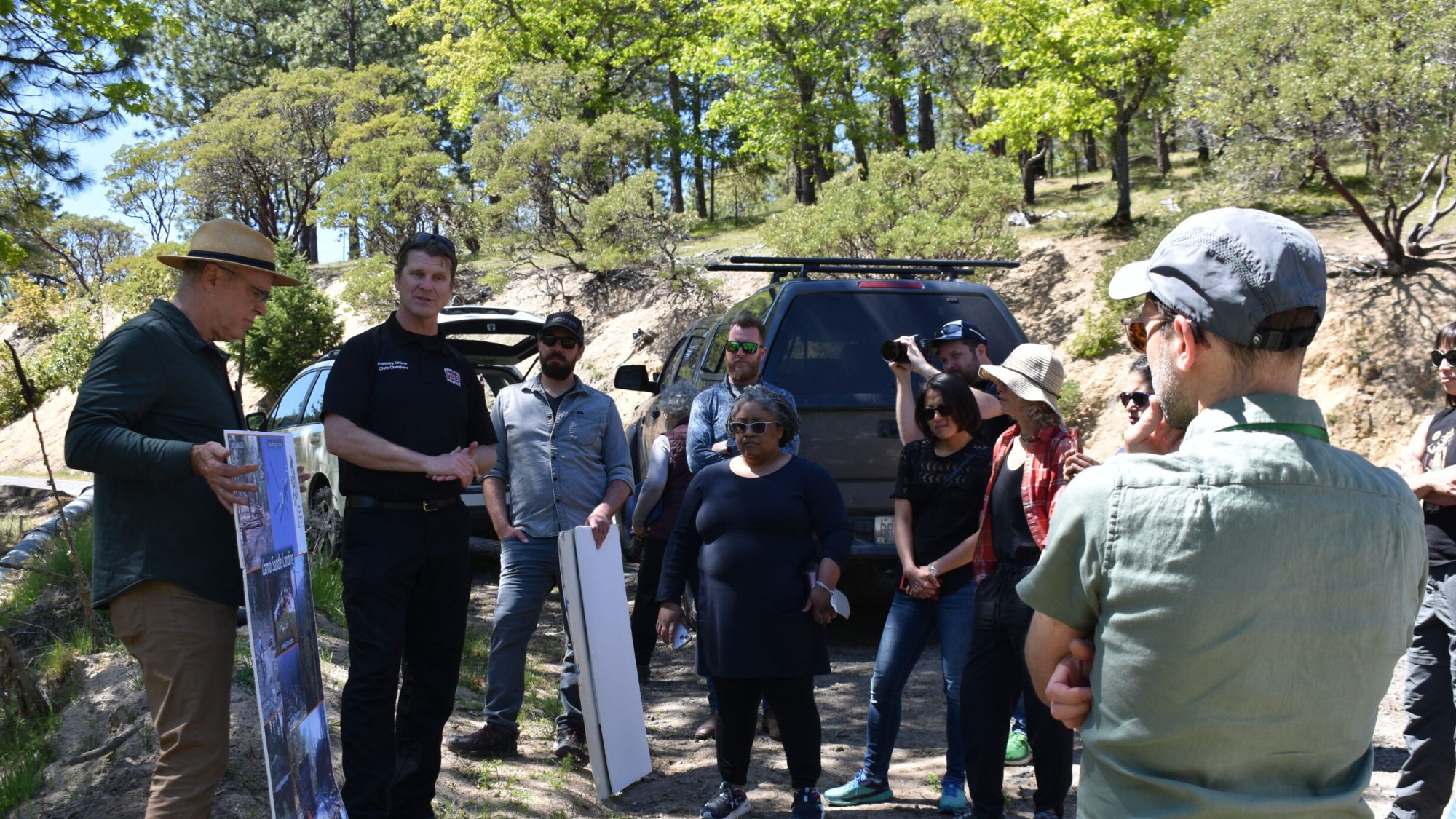 people_standing_outside_looking_at_poster