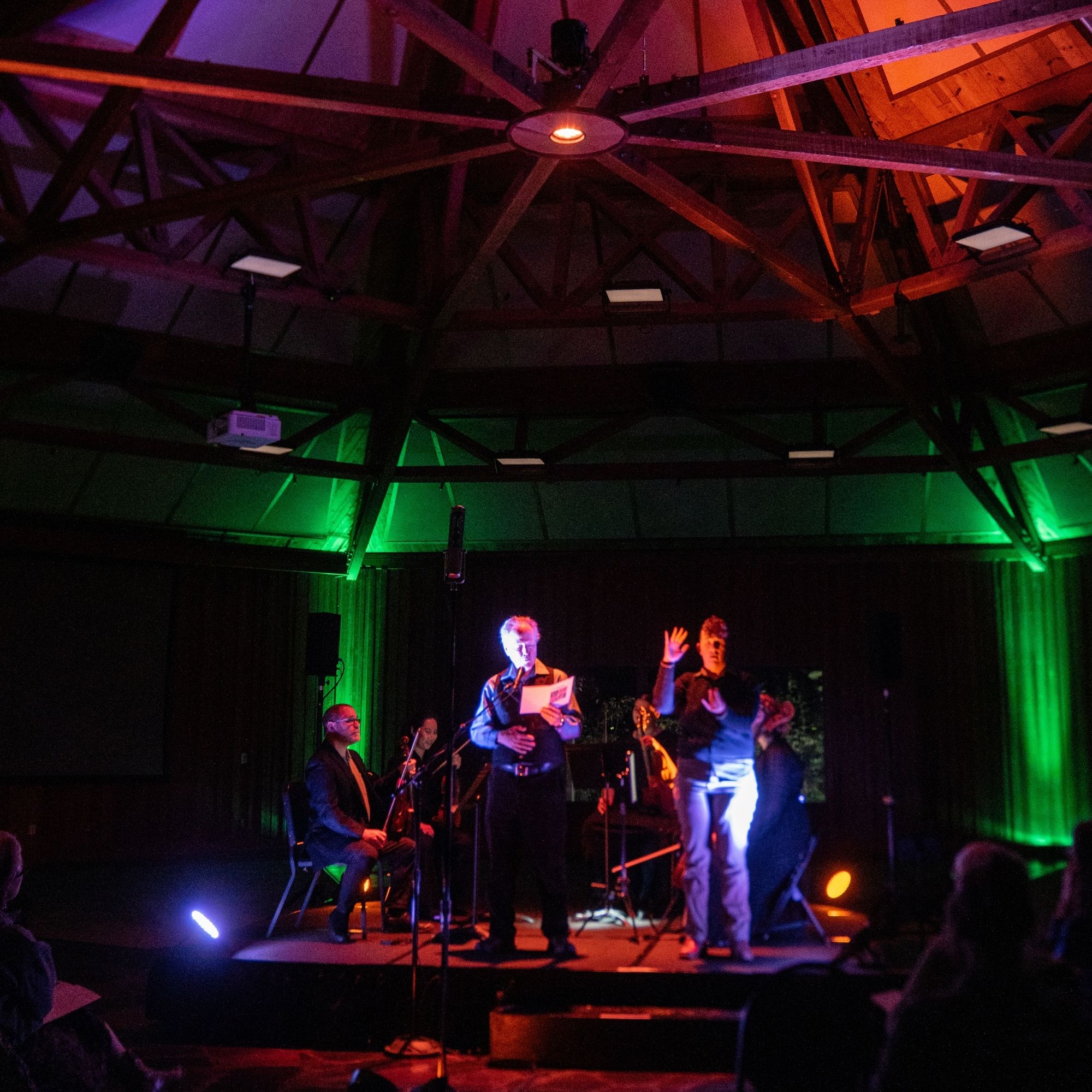 person_on_stage_reading